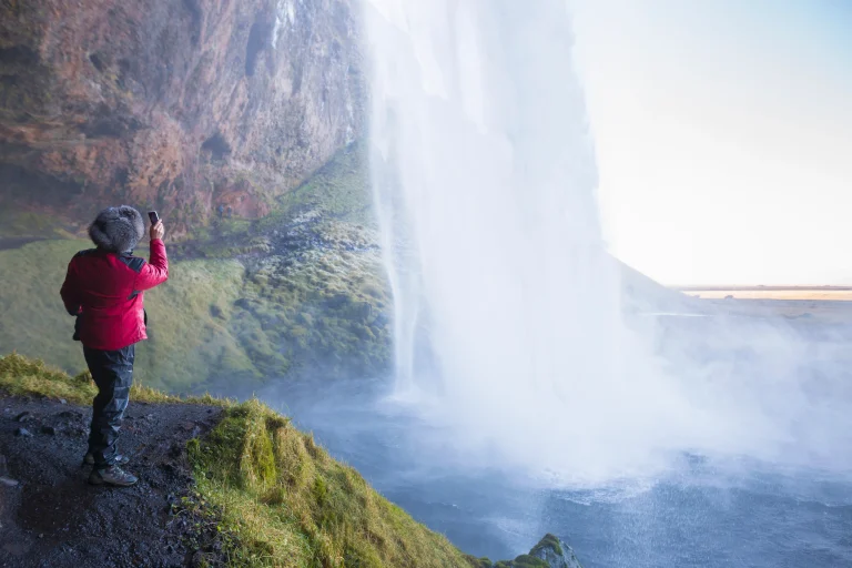 woman-photographing-seljalandsfoss-waterfall-sout-2025-04-04-17-34-49-utc